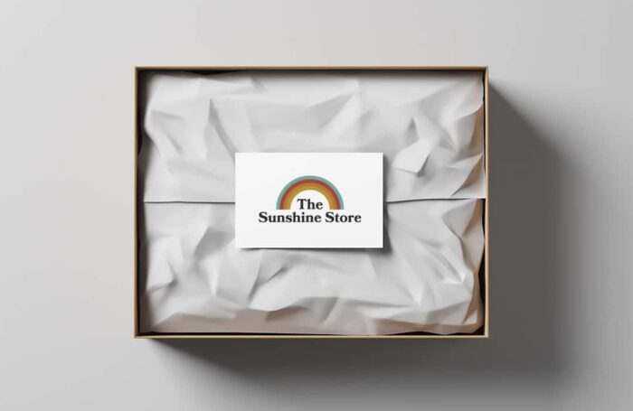 Open gift box with white wrapping paper and business card on a light background. Business gift. Mock up. Top view. 3d rendering