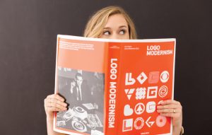 Image of Creative Director Jordis Small reading Logo Modernism for What is Logo Design