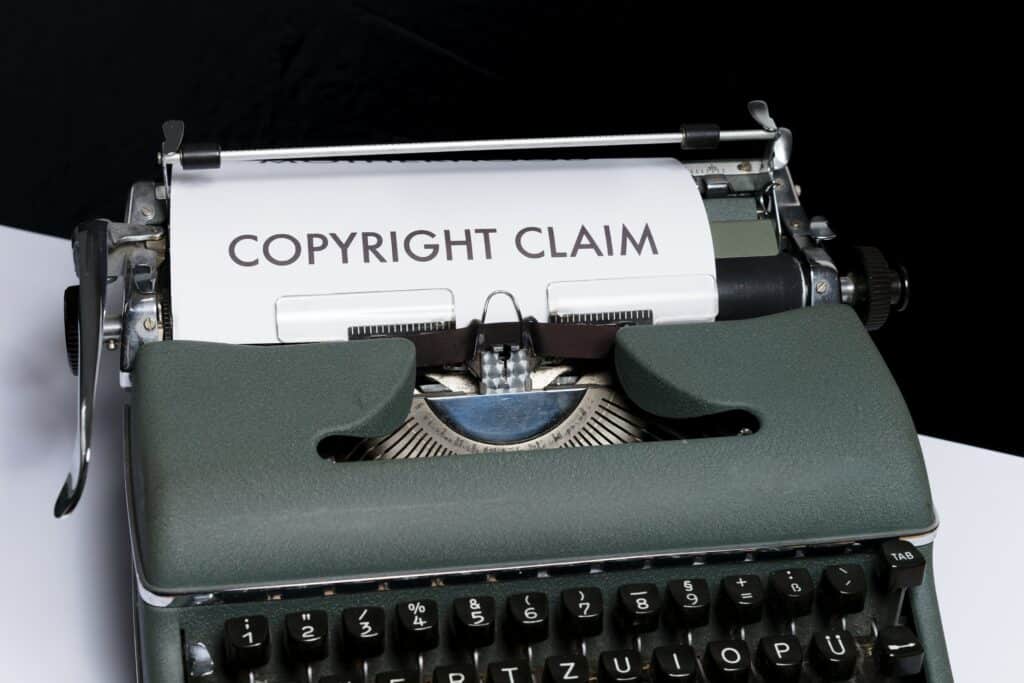 Image of old typewriter that says copyright claim in blog: Finding the balance between marketing, creativity and law when creating a brand